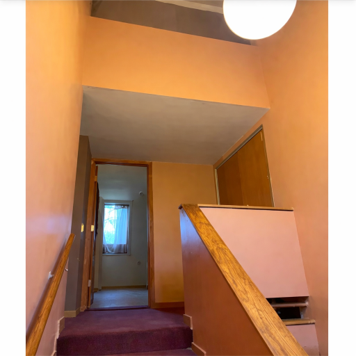 Bright upper stair landing with warm tones and clean sightlines, creating an open and welcoming transition to the upper level.