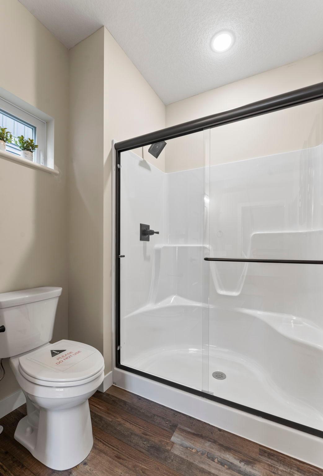 Glass shower doors are standard in all the homes. We added the bathroom window as an upgrade.
