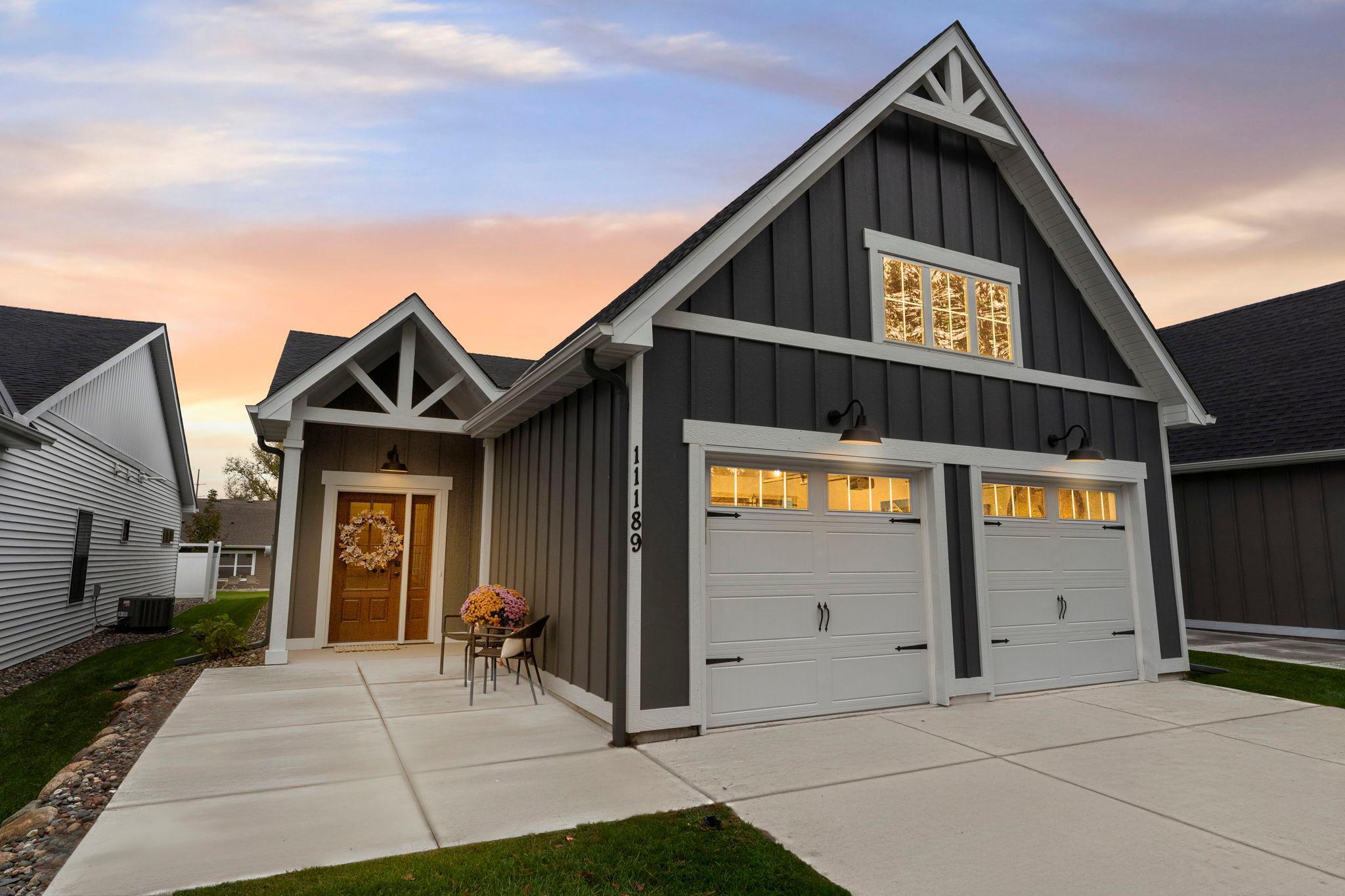 Step onto the charming front patio and watch as dusk settles over the neighborhood — the perfect spot for evening relaxation. Inside, lighting complements open-concept living spaces, creating a cozy atmosphere.