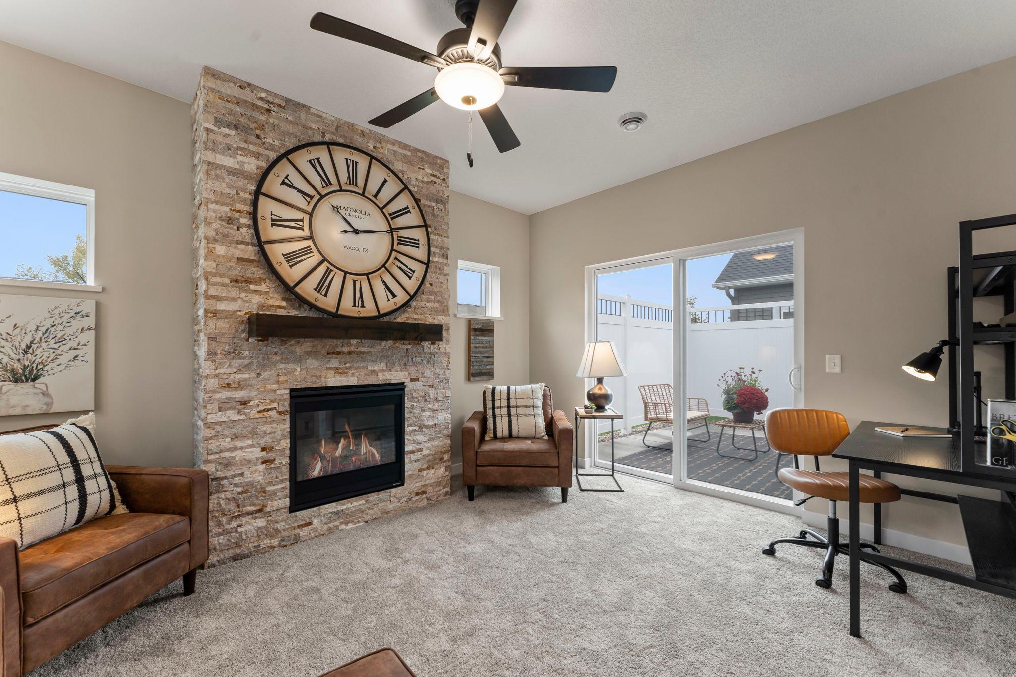 The sunroom walks out to the back patio with a privacy fence.