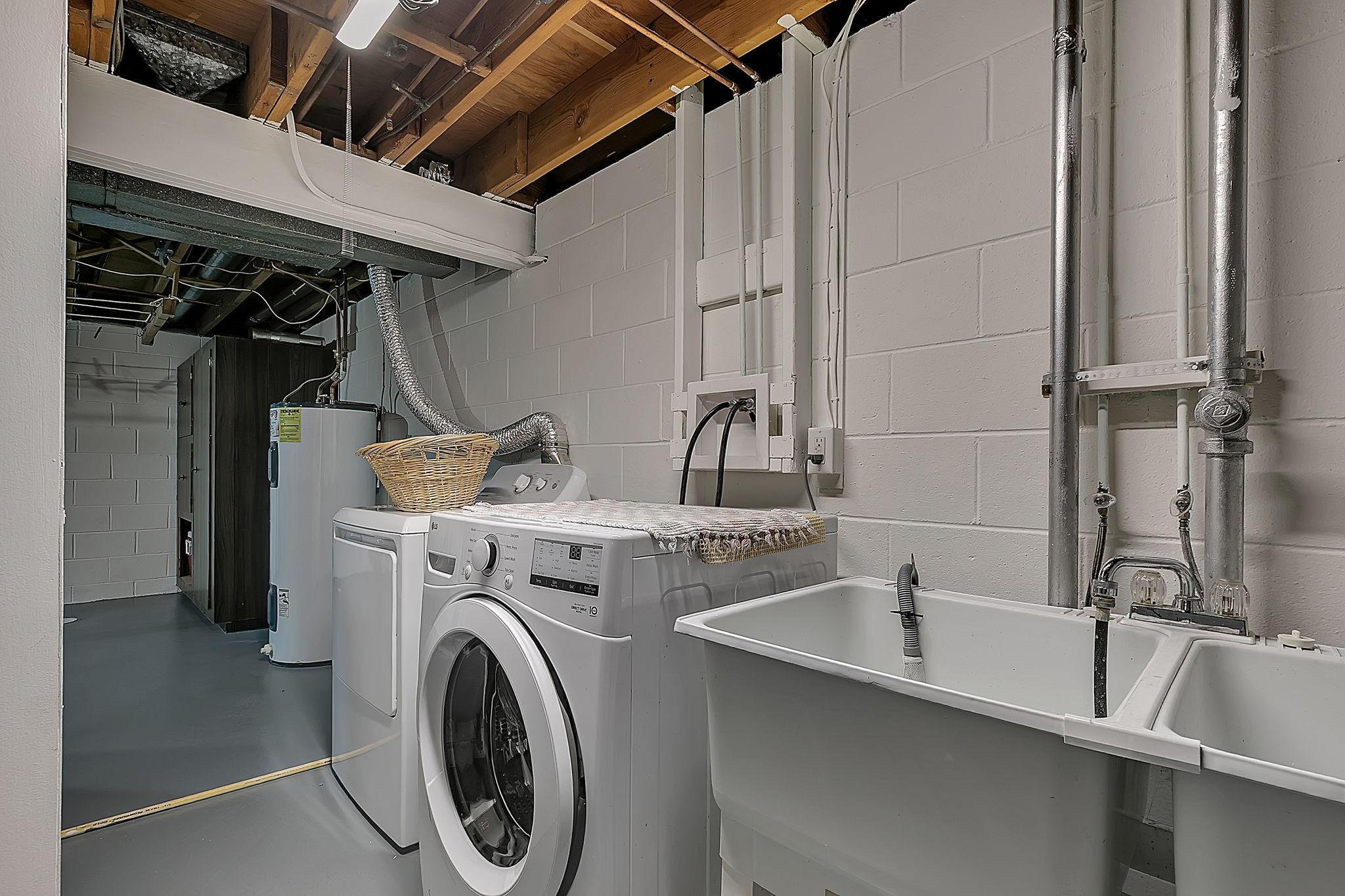 Spacious laundry area with utility sink.