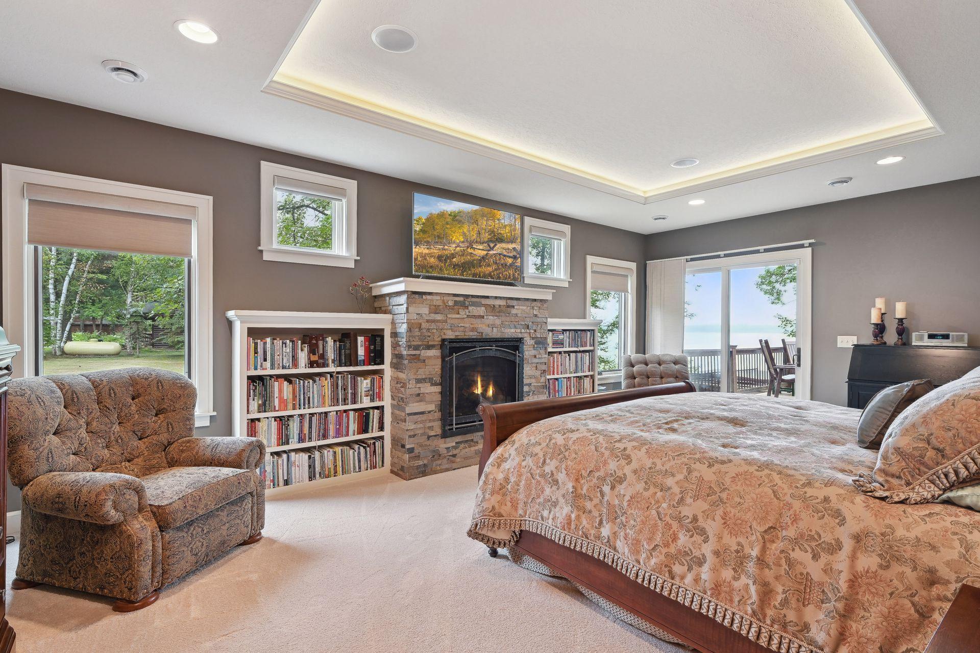 Lovely primary bedroom suite enjoys a gas fireplace and direct access to the wrap around deck