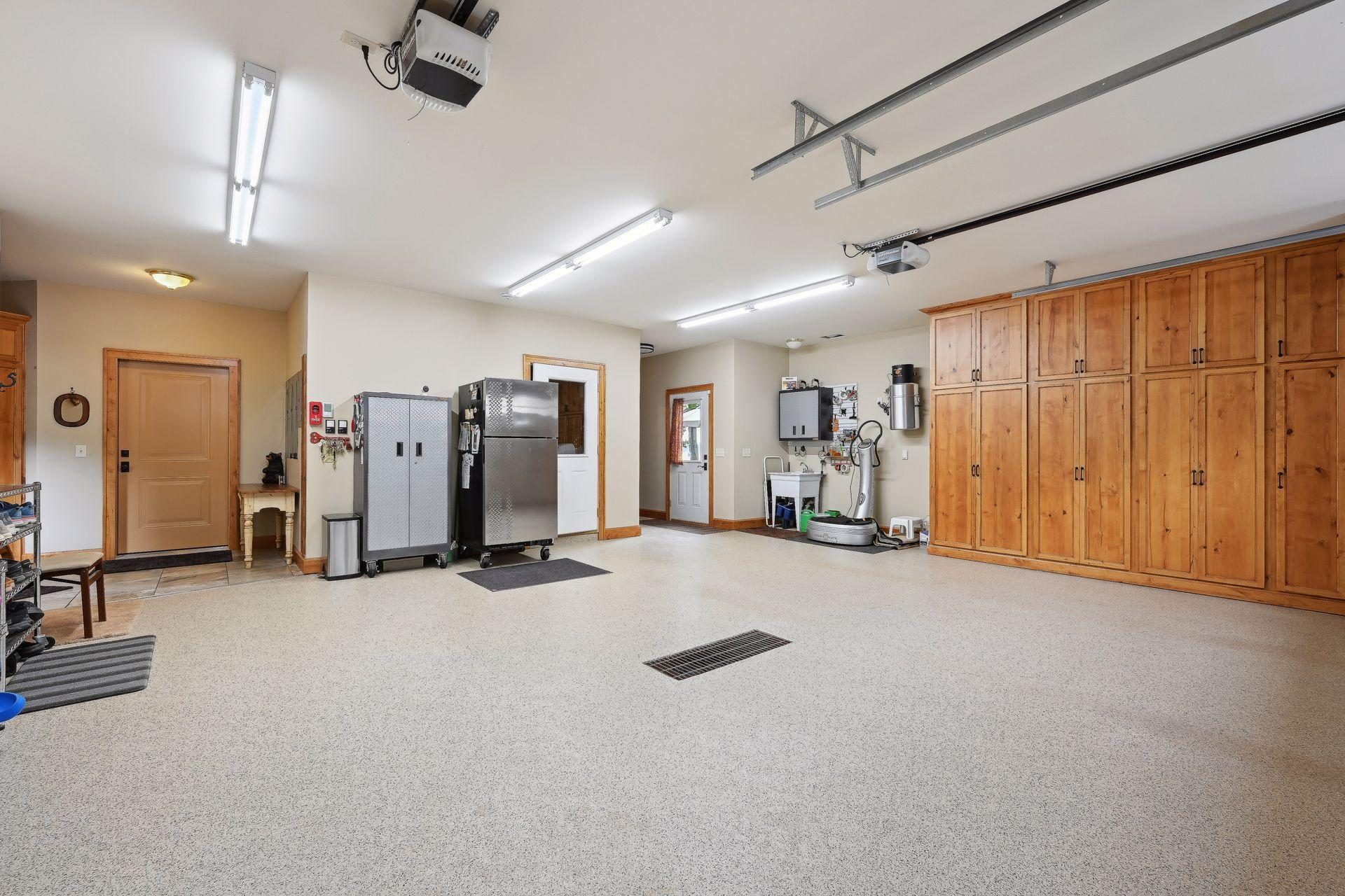 Oversized 2 stall heated, attached garage features a 2nd mudroom area, utility sink and easy access to the outdoor kitchen and storm room.
