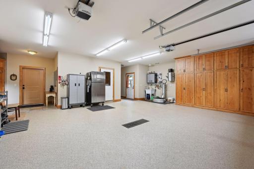 Oversized 2 stall heated, attached garage features a 2nd mudroom area, utility sink and easy access to the outdoor kitchen and storm room.