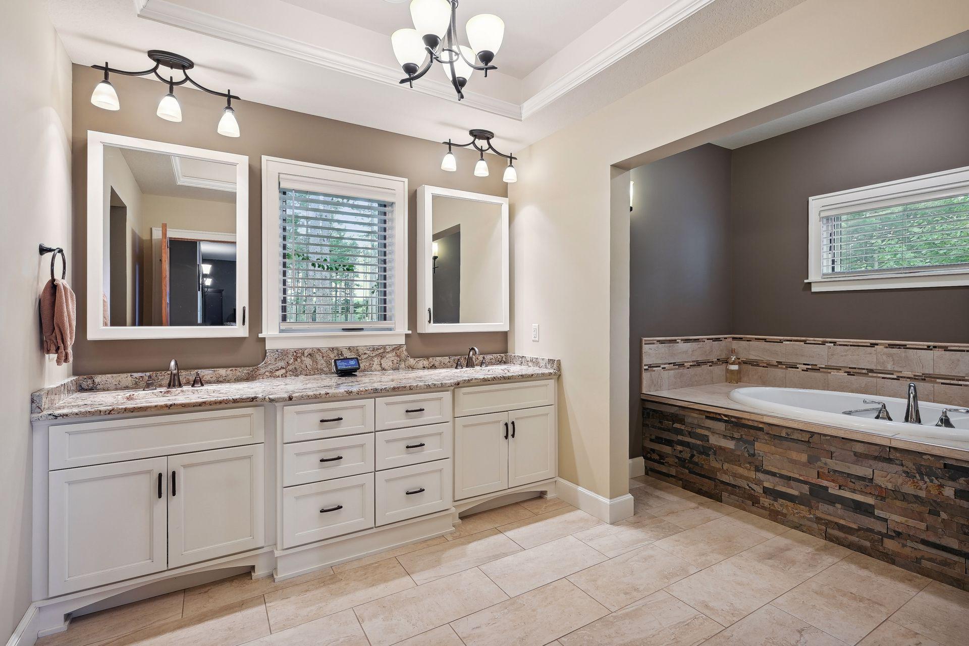 Featuring elegant fixtures, a deep soaking tub, a sleek walk-in shower and double vanities the primary bath is designed for ultimate comfort and convenience
