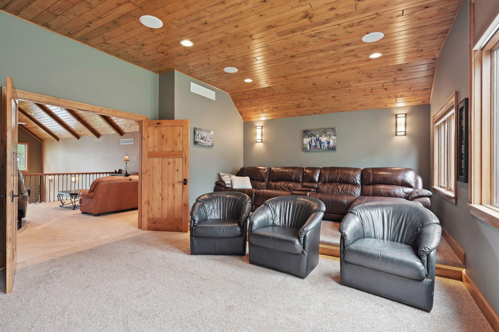 The home theater room, complete with tiered seating, offers a cinematic experience in the comfort of home