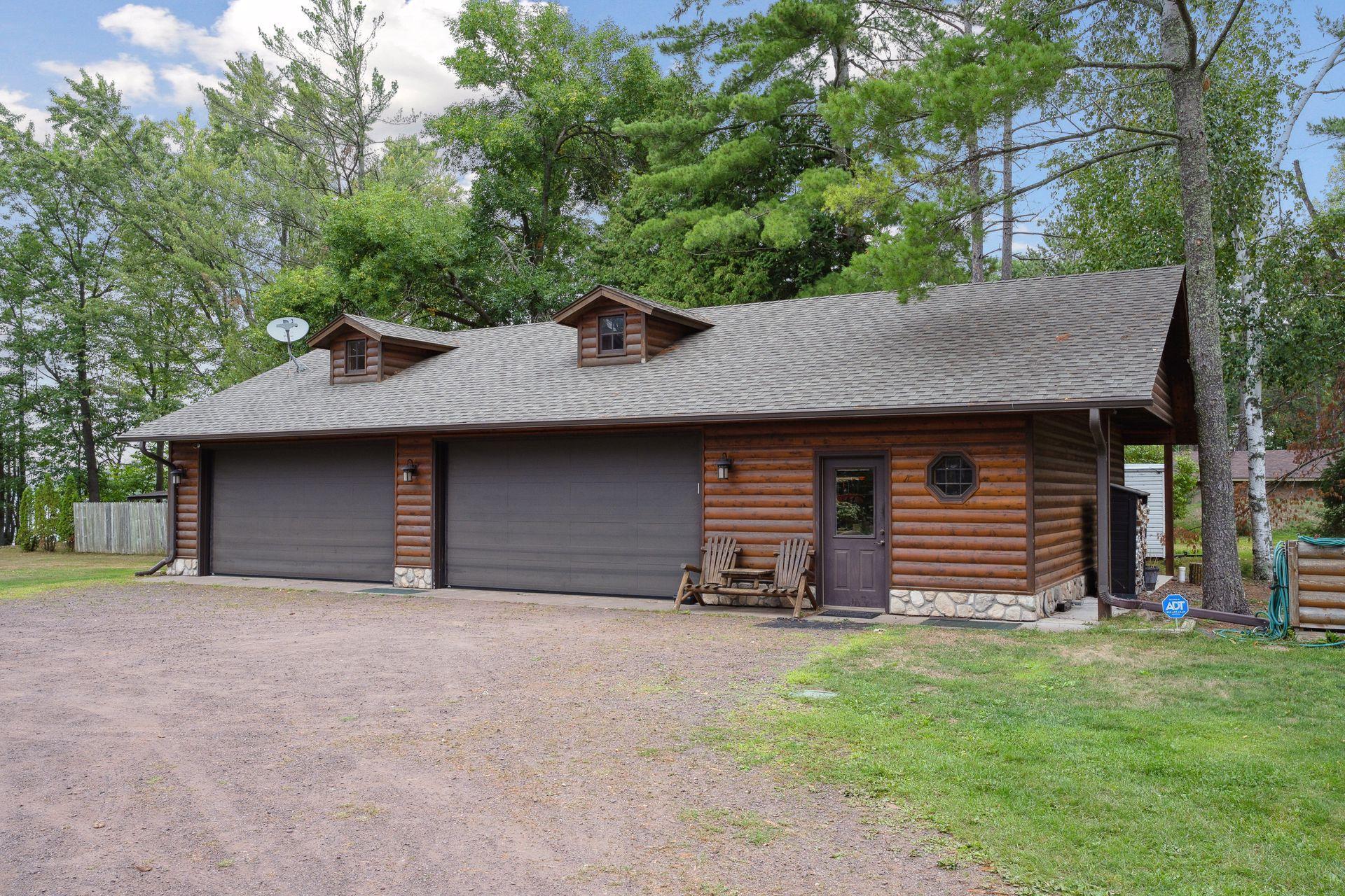 4 stall detached garage and seasonal bathhouse shares a driveway with the main house. Includes exterior RV hook-up and screens for the overhead doors that can turn it into a bug free party room