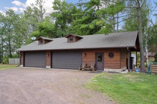 4 stall detached garage and seasonal bathhouse shares a driveway with the main house. Includes exterior RV hook-up and screens for the overhead doors that can turn it into a bug free party room