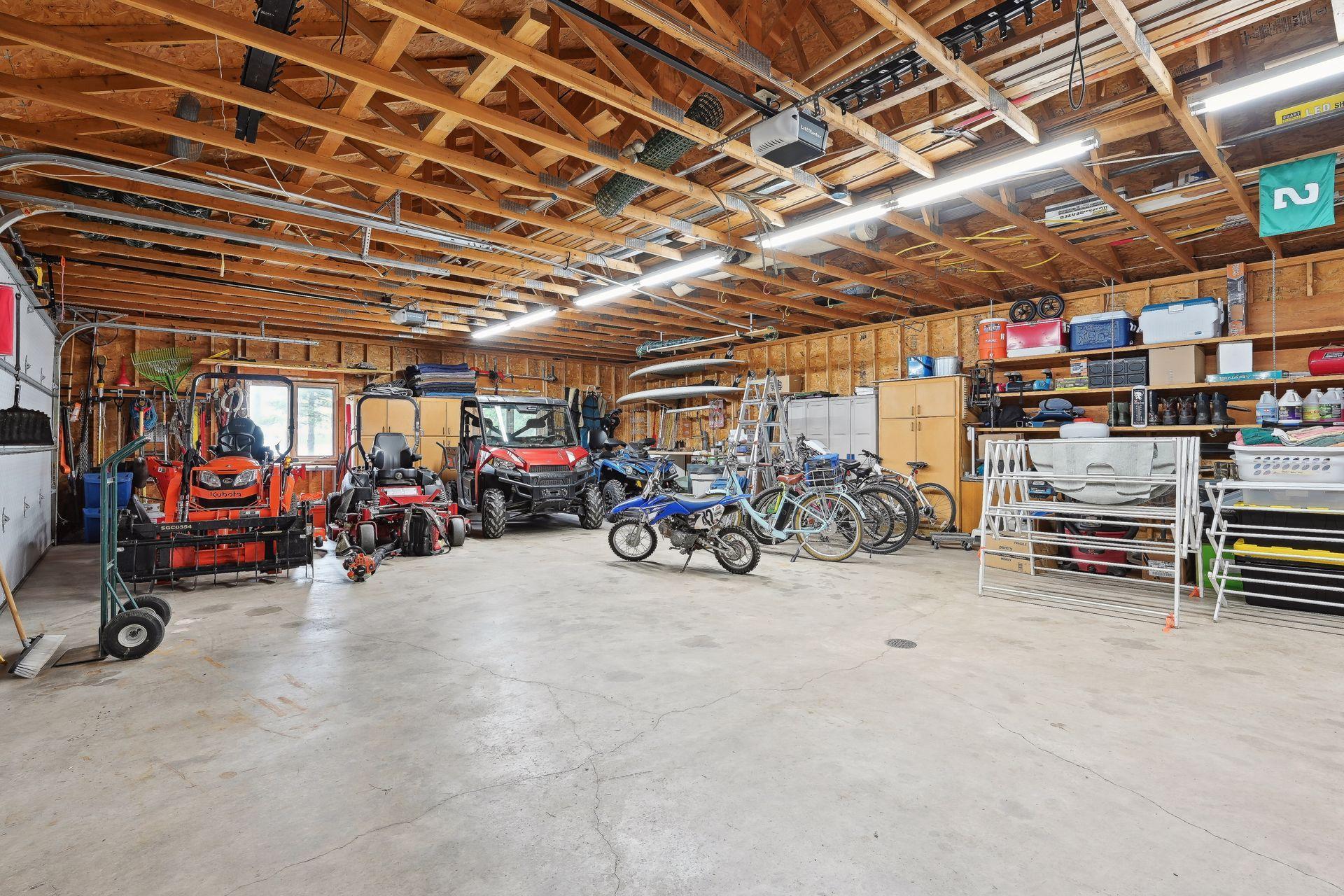 Oversized detached 4 stall garage provides plenty of storage room for outdoor gear and even has roll down screens for the overhead doors, workshop space and a bath house area with a washer and dryer