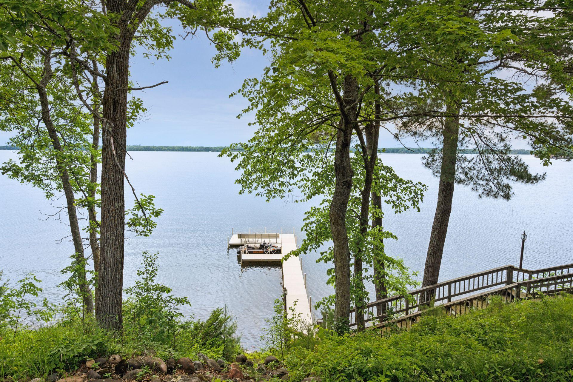 A lovely waterfall feature flows to the dock and swimming area