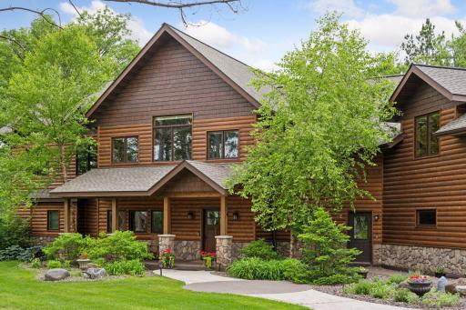 Inviting entry walk includes a covered front porch, lovely landscaping and a no-step second entry door
