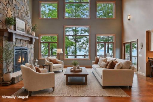 Soaring wall of windows brings the outdoors in while the stacked stone fireplace keeps things cozy.