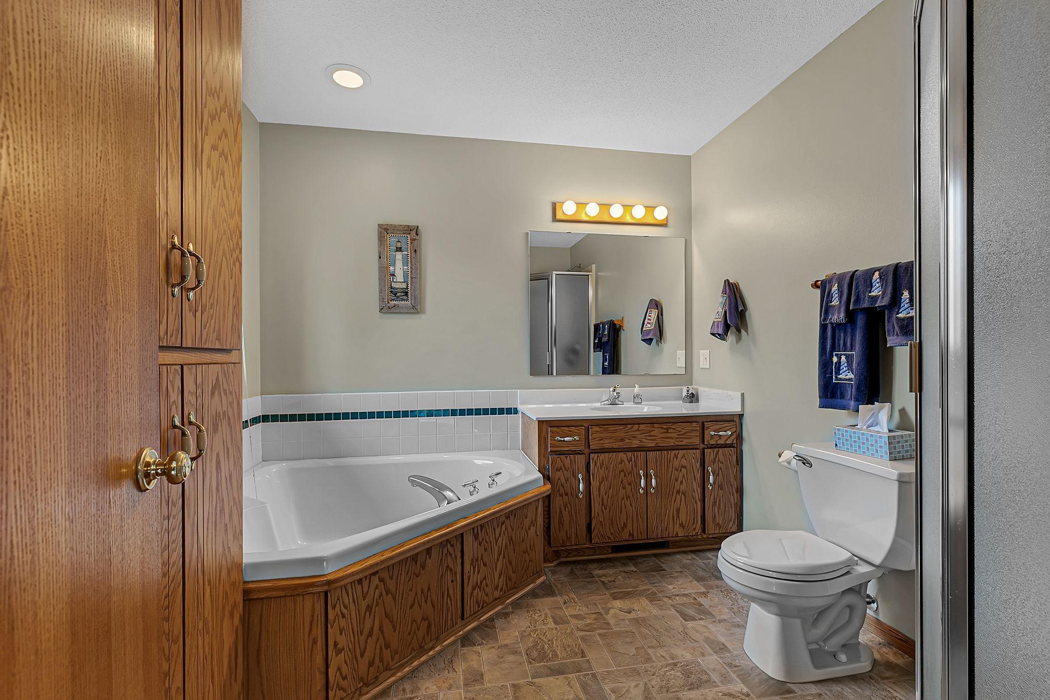 Primary bathroom with a separate tub and shower.