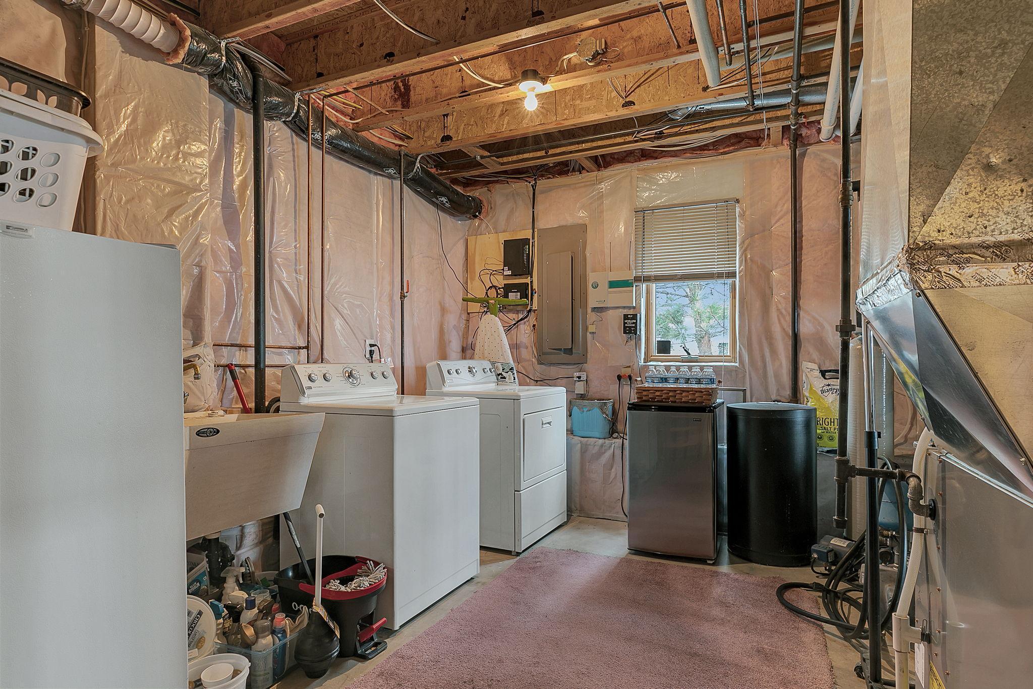 Lower level laundry with a utility sink.