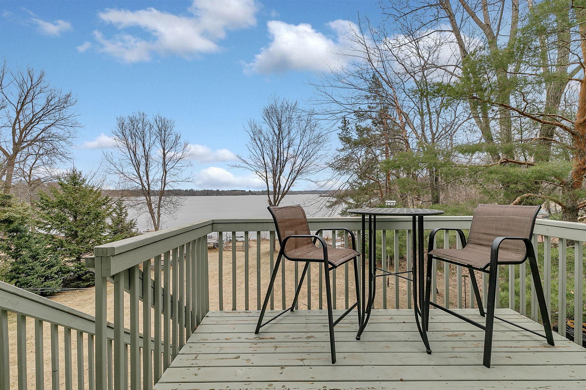 Deck provides a peaceful retreat with sweeping backyard and lake vistas.