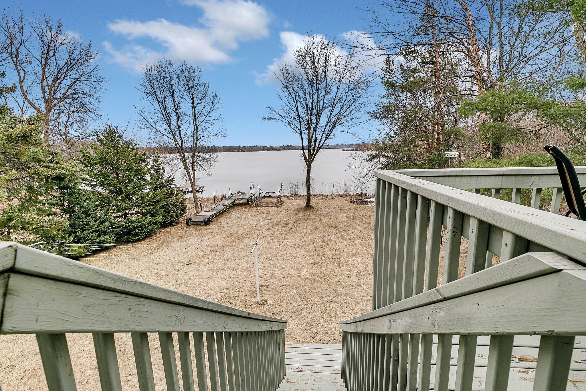 Deck walks down to expansive backyard.