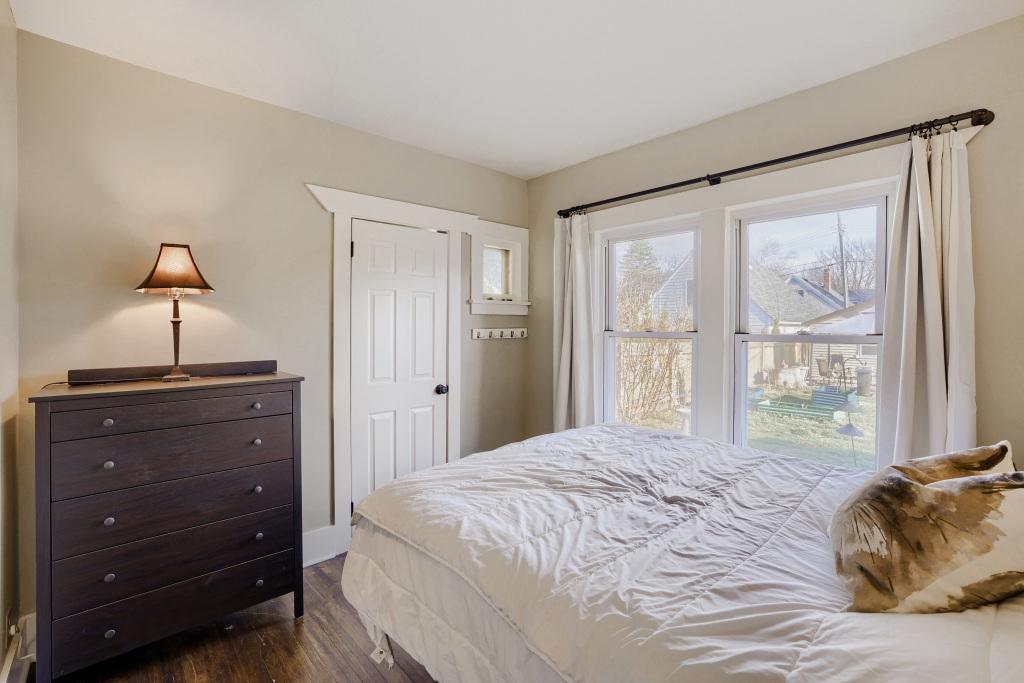 The second bedroom on the main level with views of the backyard.