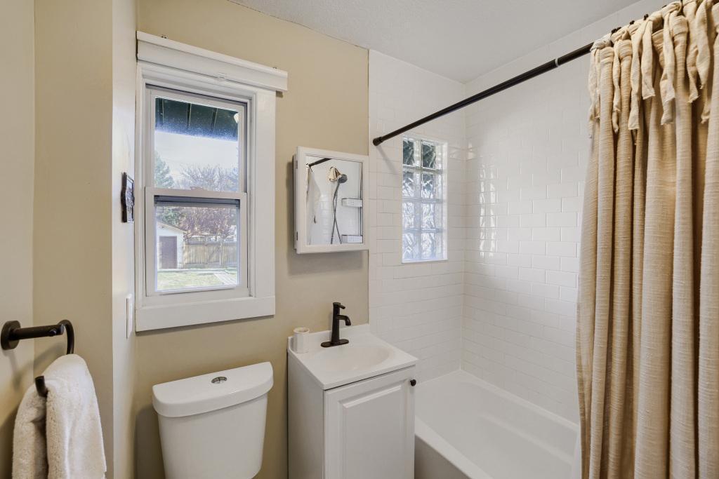 The main level updated bathroom offers a privacy glass block window in addition to the regular window for ample light! Enjoy subway tile in the shower area along with an updated floor, toilet and vanity.