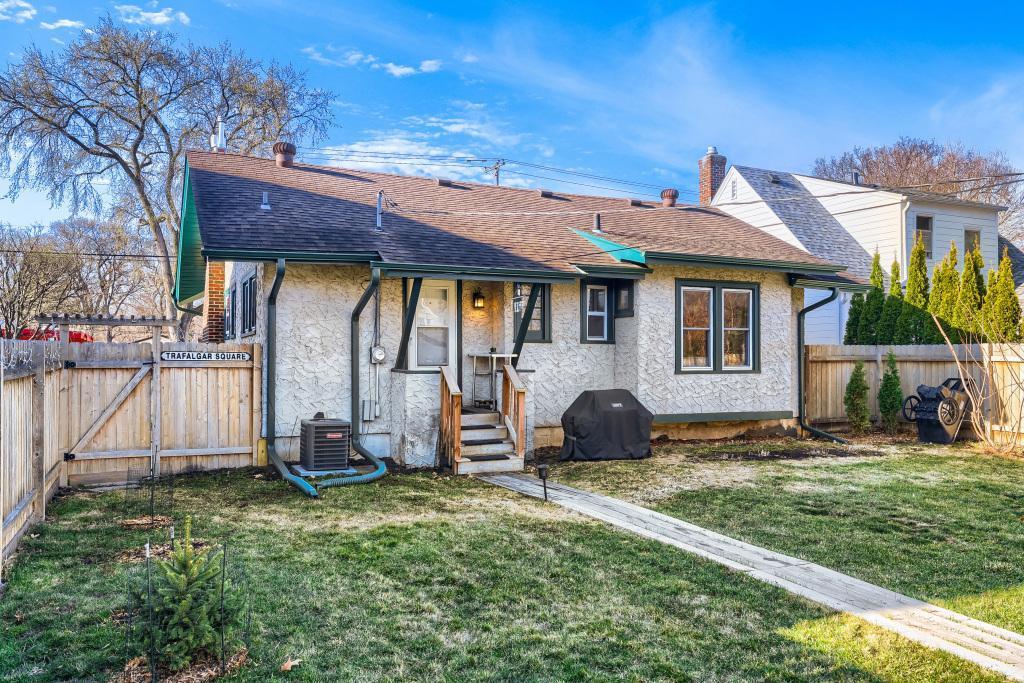 The back of the home and walkway to the garage and yard.