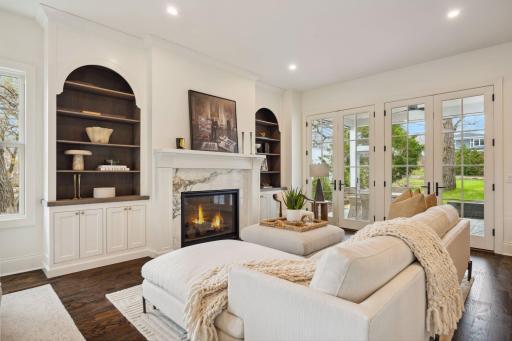 Gorgeous built-ins surround the fireplace with marble surround