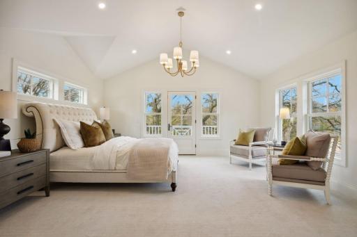 Primary suite with private balcony overlooking pond