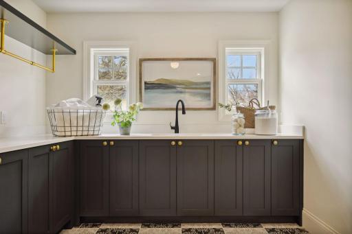 Laundry room on upper level with doors to hallway AND to primary bedroom closet
