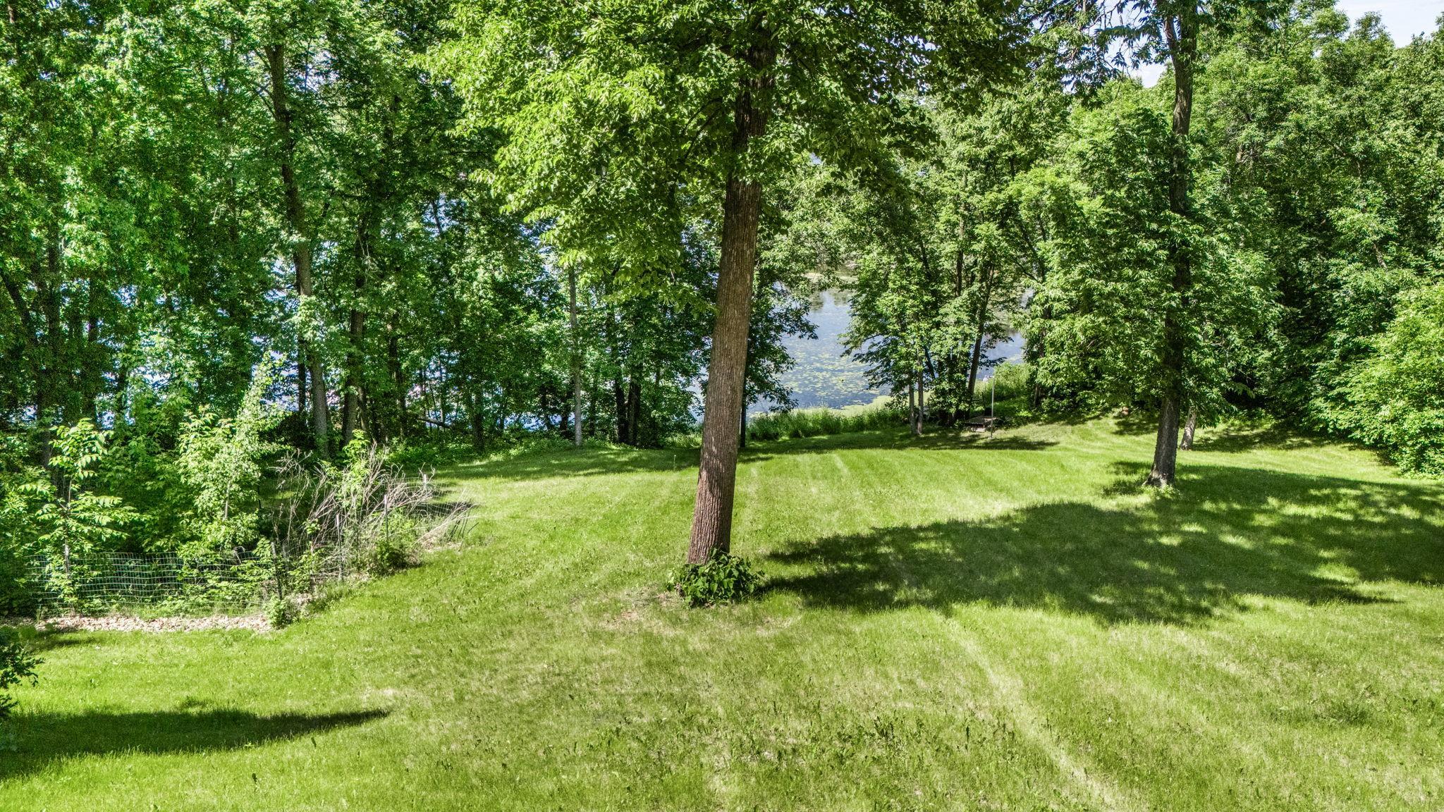 Immersed in nature with a scenic tree-lined setting and tranquil views.
