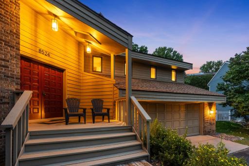 Beautifully illuminated at twilight, showcasing the warmth and character of this special home.