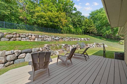 Beautiful tiered boulder retaining walls add character and dimension to the backyard while complementing the natural setting.