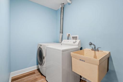 The laundry room also houses the new furnace installed in 2025, part of an updated heating and cooling system with a new air conditioner and three-zone temperature control.