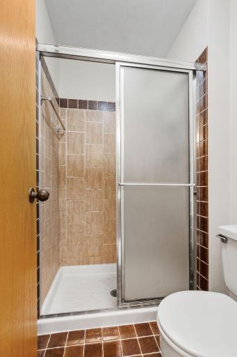 1. The tiled shower adds a classic finish to the primary bath.