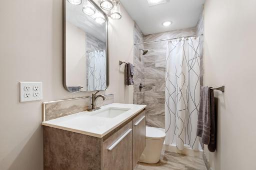 Beautifully selected finishes bring a polished, custom look to the newly added lower-level bathroom.