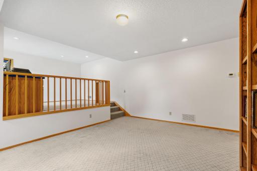 A few steps up lead to the office, giving the workspace its own defined place within the lower level.