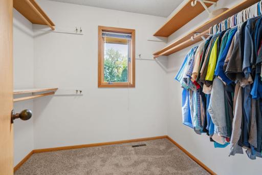A walk-in closet keeps clothing and accessories organized and within reach.