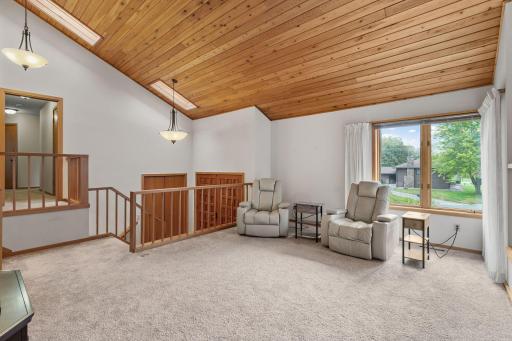 Soaring 15-foot tongue-and-groove wood ceilings and natural light from the skylights create a striking first impression in this inviting living room.