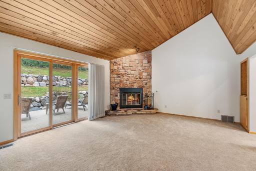 The stone wood-burning fireplace creates a striking focal point and cozy warmth on cooler evenings.