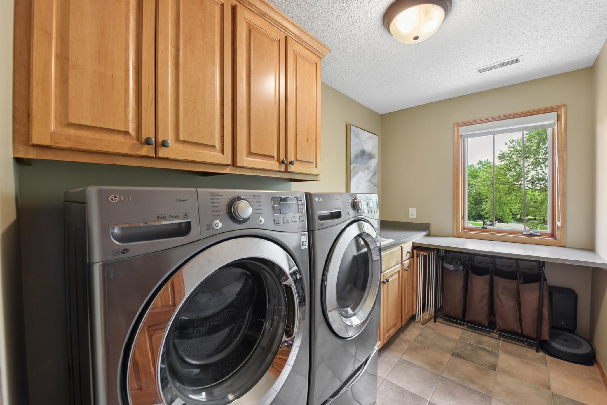 Upper level laundry with storage, sink and folding stagion