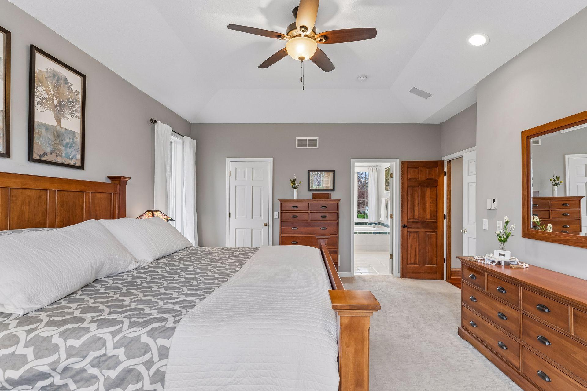 A third view of the primary suite showing location of the walk-in closet and luxurious full bath.