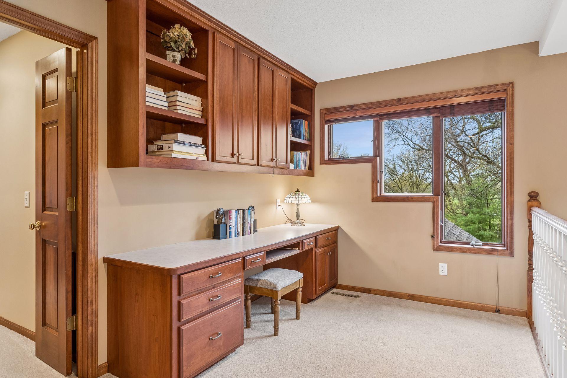 Upper level loft with a built-in desk and more amazing windows.