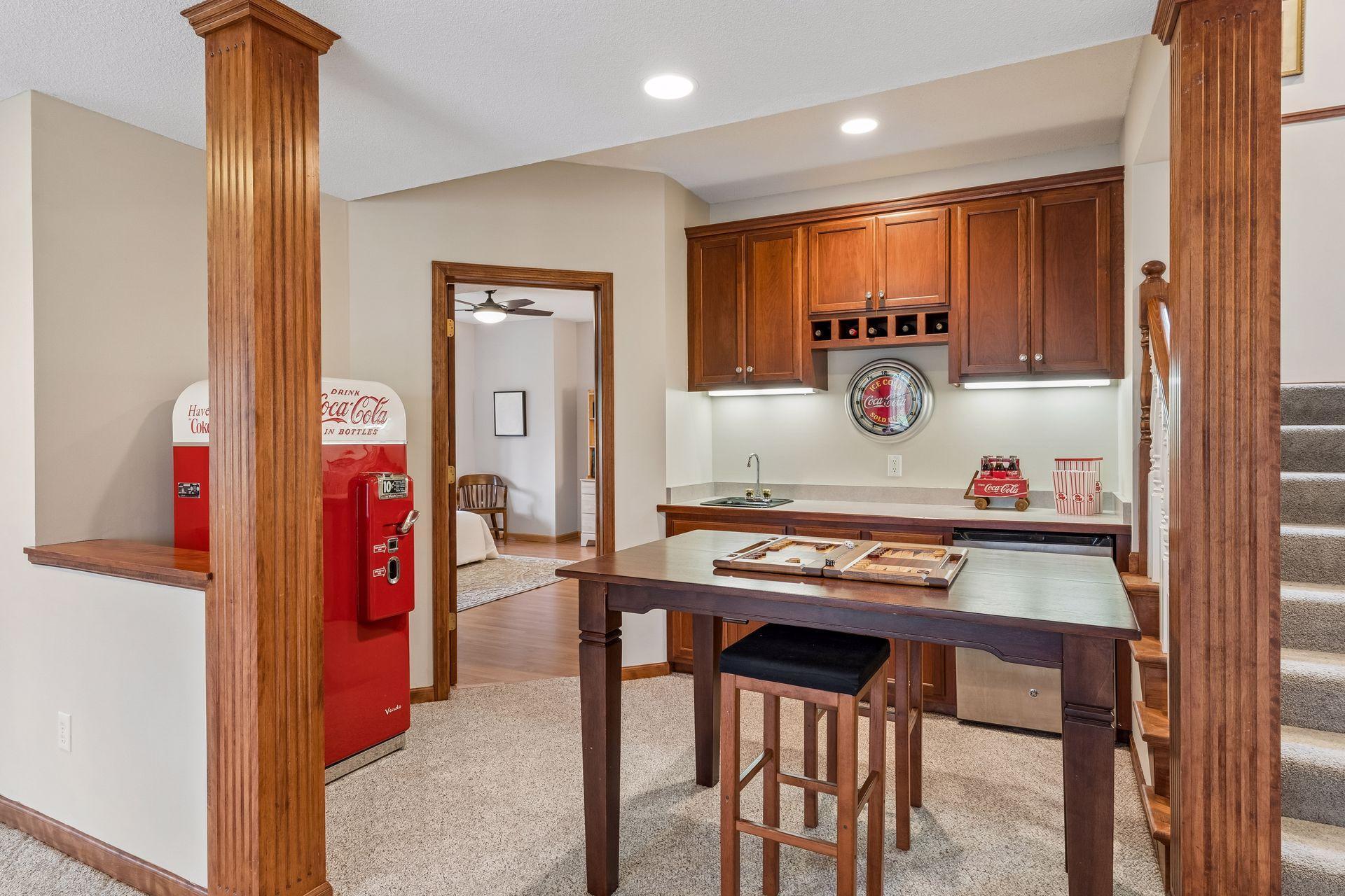 Enjoy playing games and snacking while watching others shoot pool. Note the beautiful fluted columns repeated throughout this home.