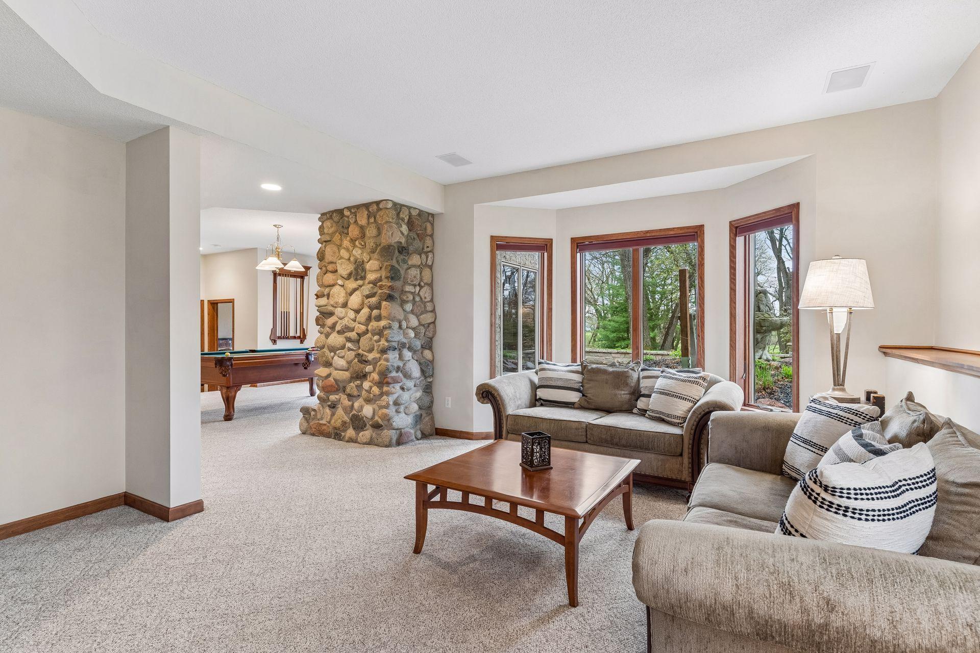 Another view of the family room showing the bay windows that overlook a large paver patio.