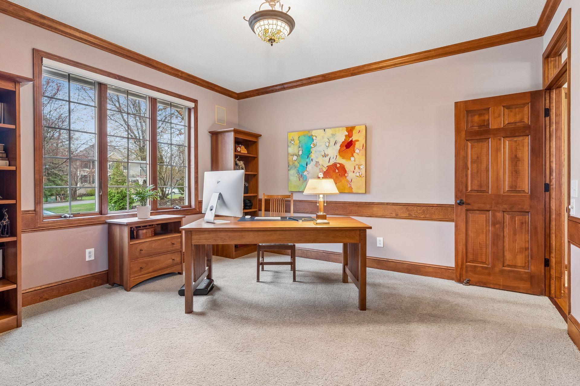 Originally designed to be a formal dining room, this room currently serves as a spacious in-home office.