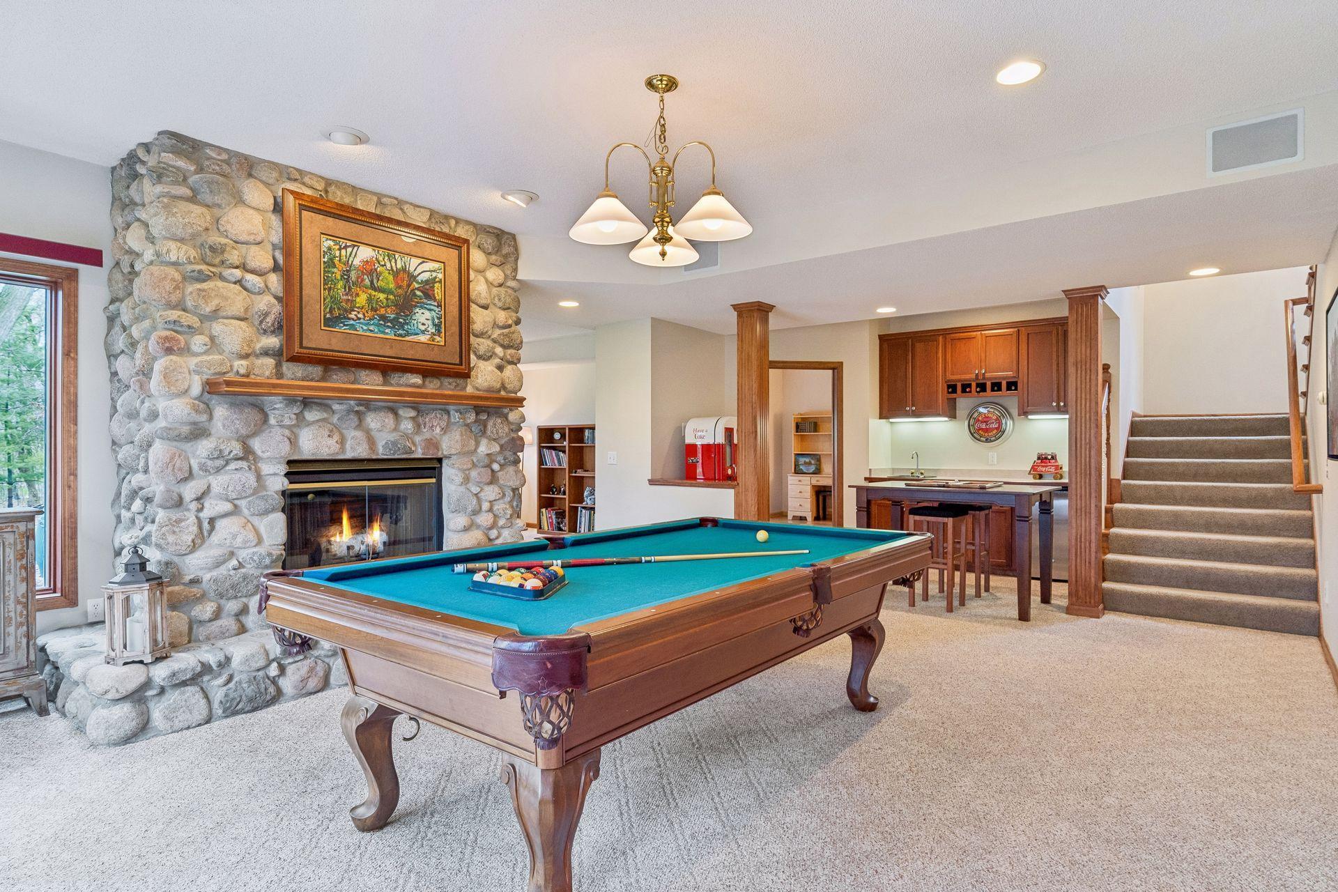A second view of the billiard area and bar/game area. Enjoy surround sound for added ambiance and central vacuum throughout this home.