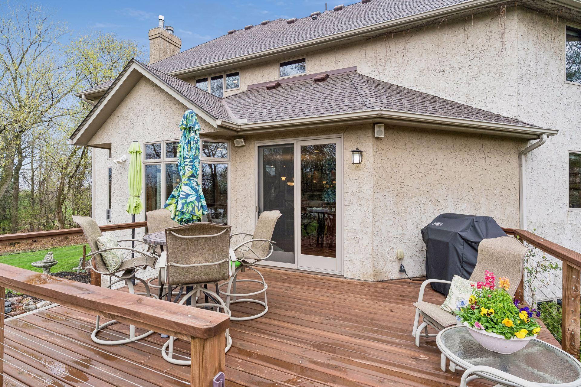 Walkout from the main level to dine and entertain outdoors, complete with speakers and decorative lighting for ambiance.