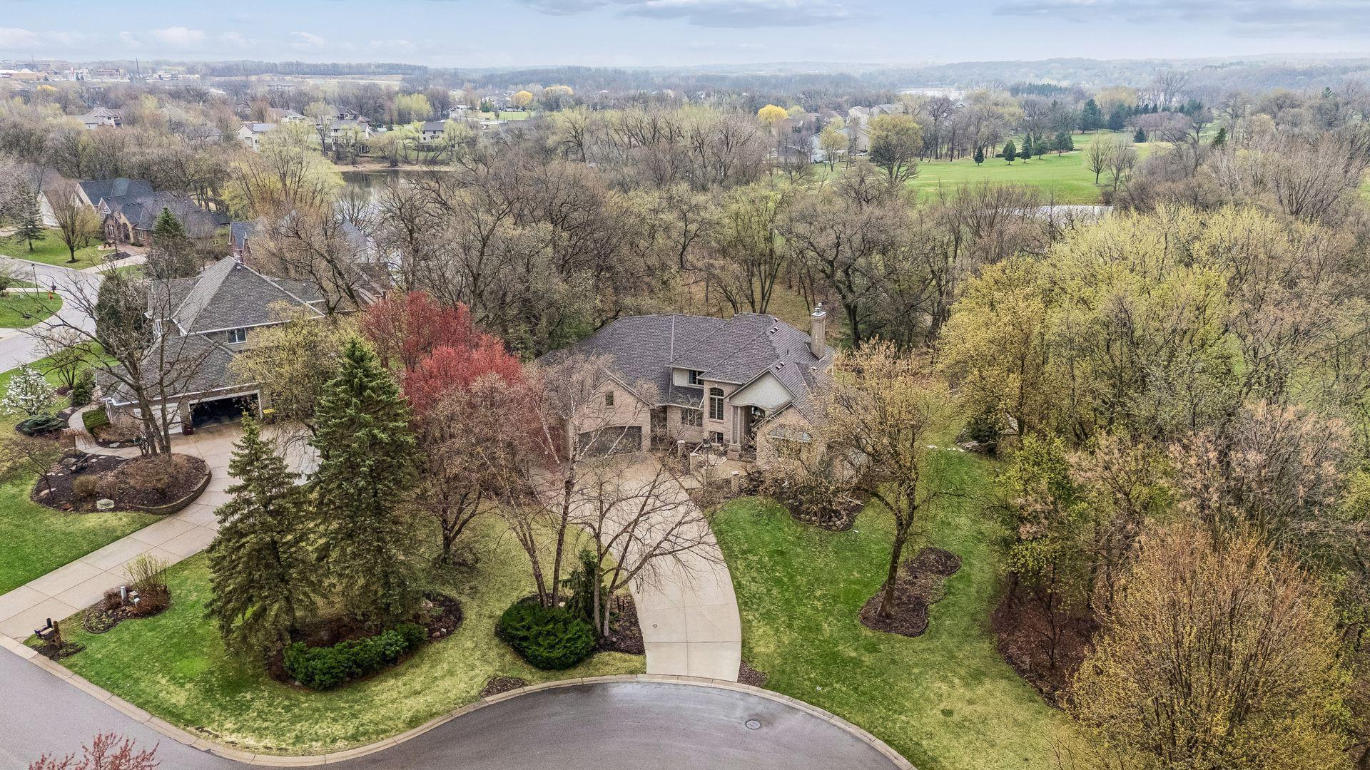 Aerial view of home and Brackett's Crossing Golf Course behind it.