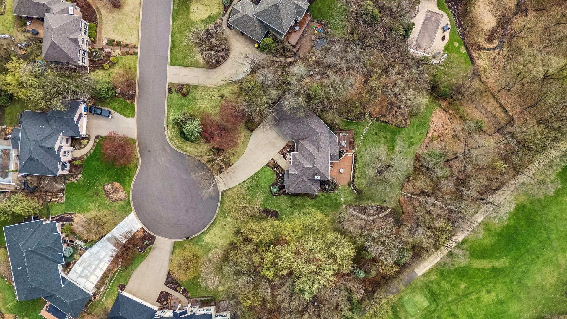 Aerial view of roof line and vacant lot next to home, also owned by the sellers of this home.