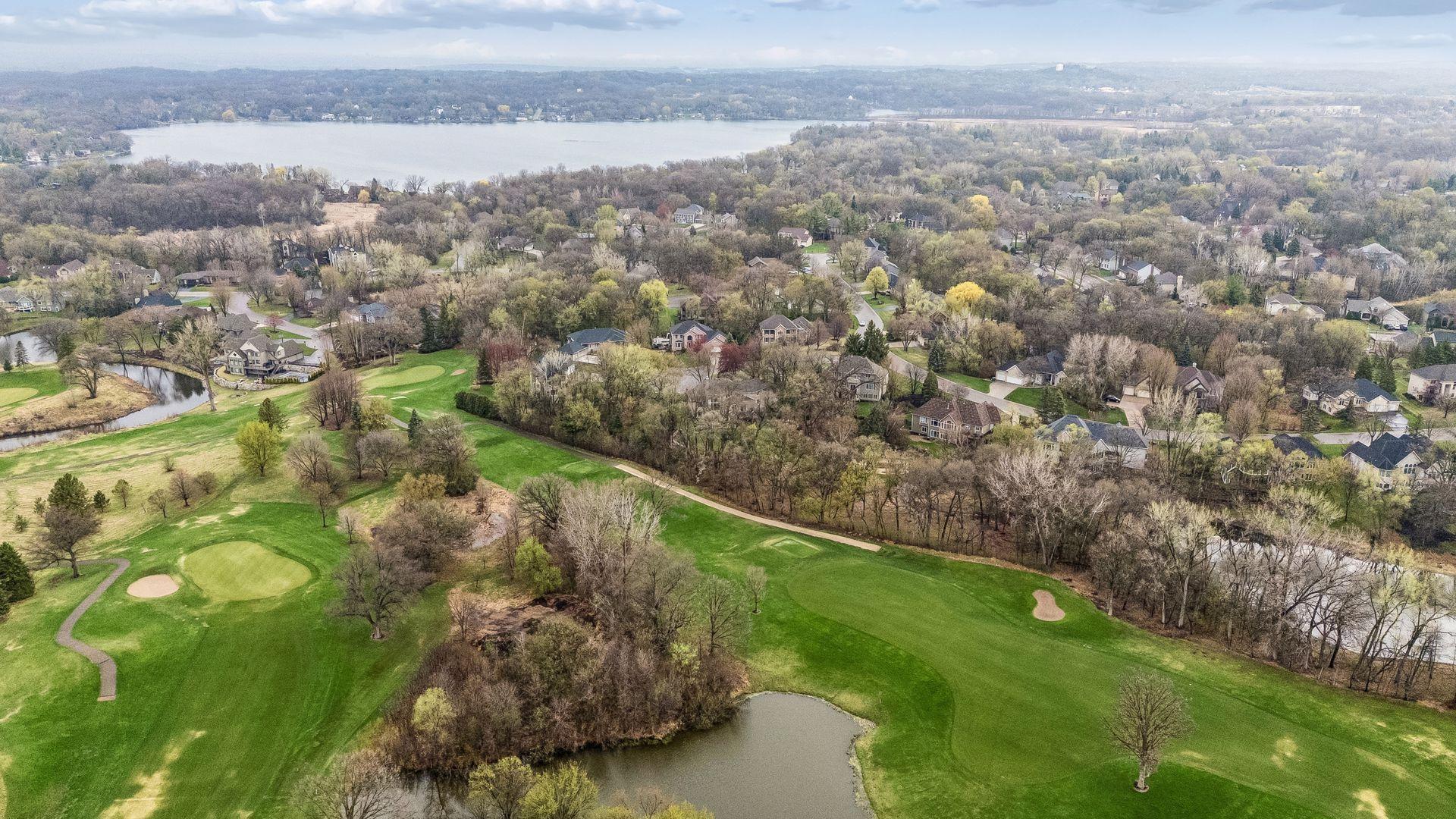 Aerial view of golf course behind home.
