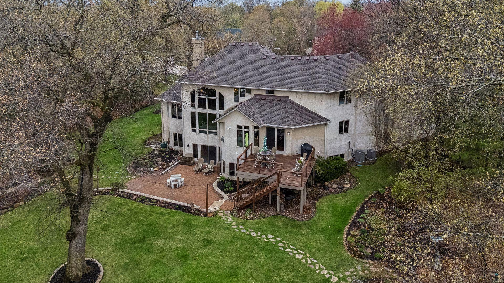 Aerial view of back of home, patio and deck.