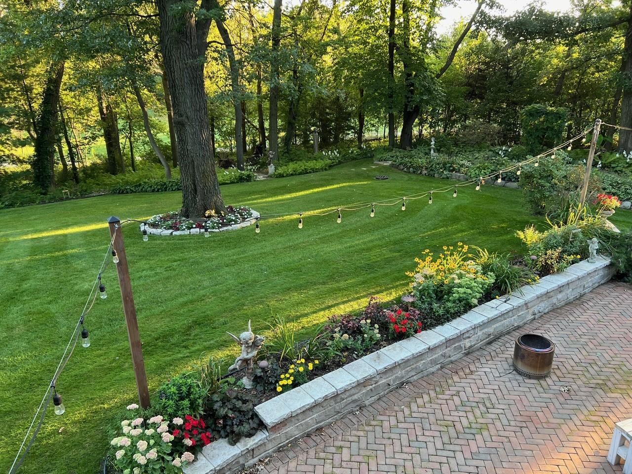 Stunning and private backyard setting surrounded by mature trees and gorgeous perennial gardens that lend a "park like" feel.