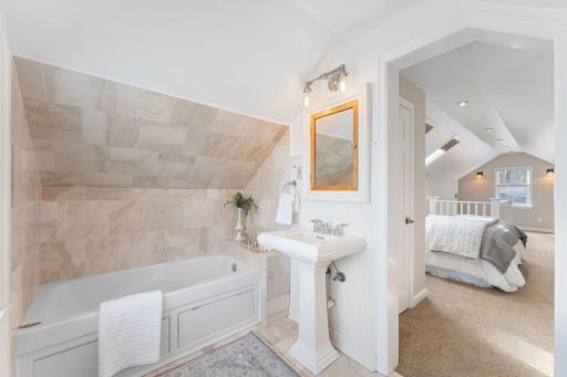 Spa-like bath features a jetted soaking tub.
